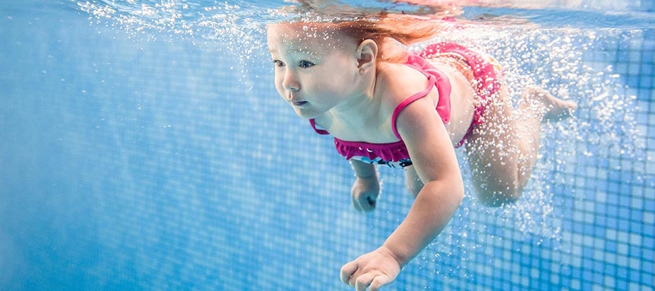 young child swimming underwater